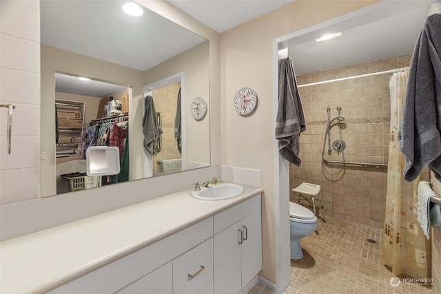 bathroom featuring vanity, curtained shower, tile patterned floors, and toilet