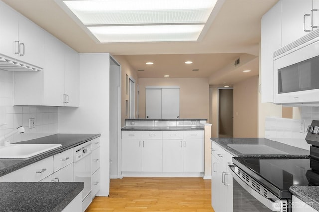 908 E Bay Dr NE Unit 203, Olympia, WA 98506 - kitchen featuring white appliances, a sink, light wood-style flooring, backsplash, and white cabinetry