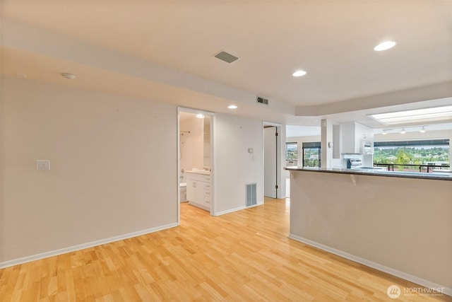 908 E Bay Dr NE Unit 203, Olympia, WA 98506 - empty room featuring light wood-type flooring, plenty of natural light, baseboards, recessed lighting, and a smoke detector
