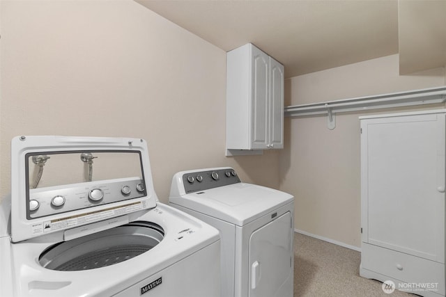 908 E Bay Dr NE Unit 203, Olympia, WA 98506 - laundry area featuring washing machine and dryer, cabinet space, and baseboards