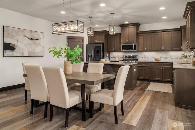 dining area with dark hardwood / wood-style floors and sink