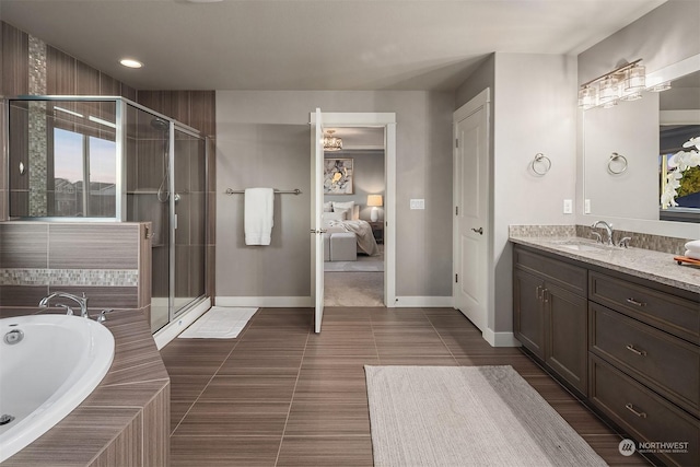 bathroom with tile patterned flooring, vanity, and plus walk in shower