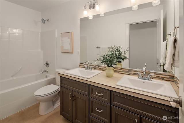 full bathroom with washtub / shower combination, vanity, toilet, and backsplash