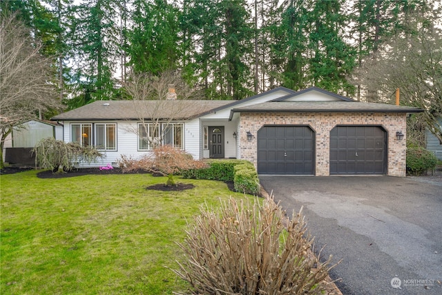 ranch-style home with a front yard and a garage