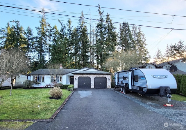 view of front of property featuring a garage and a front yard