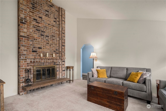 living room with carpet and a fireplace