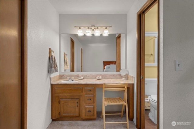 bathroom with vanity and toilet