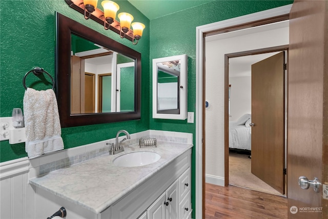 bathroom with vanity and wood-type flooring