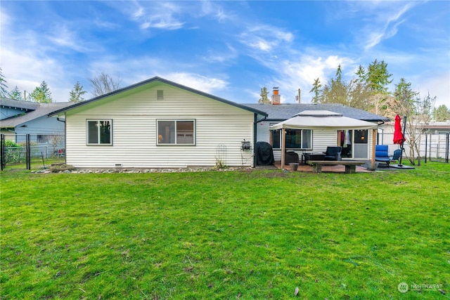 rear view of property with a lawn and a patio area