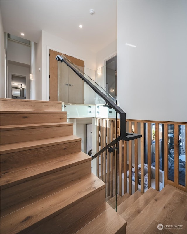 staircase featuring wood-type flooring