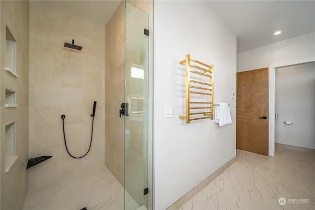 bathroom with radiator heating unit and a tile shower