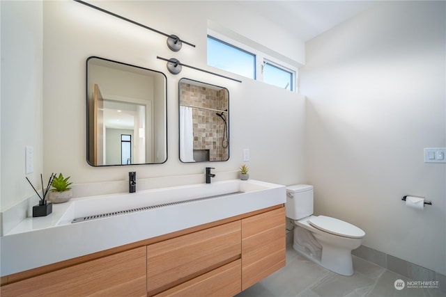 bathroom featuring a shower with curtain, vanity, toilet, and tile patterned flooring