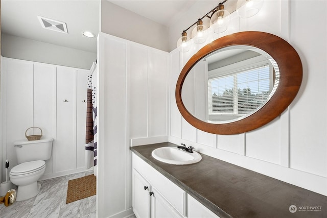 bathroom featuring vanity and toilet