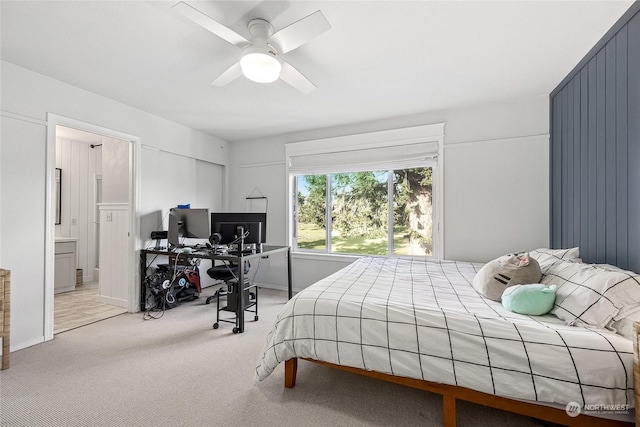 carpeted bedroom featuring ensuite bath and ceiling fan