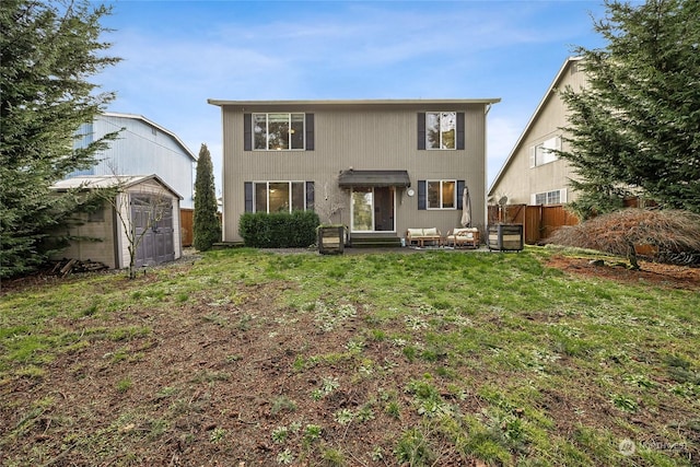 back of property featuring a storage unit and a lawn