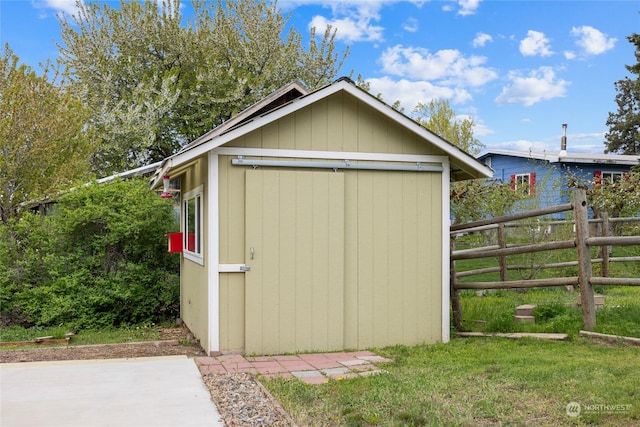 view of outbuilding featuring a lawn