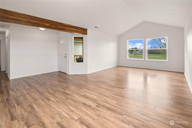 unfurnished living room featuring vaulted ceiling and wood-type flooring