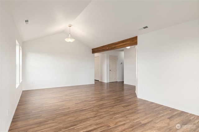 unfurnished room with dark wood-type flooring and vaulted ceiling