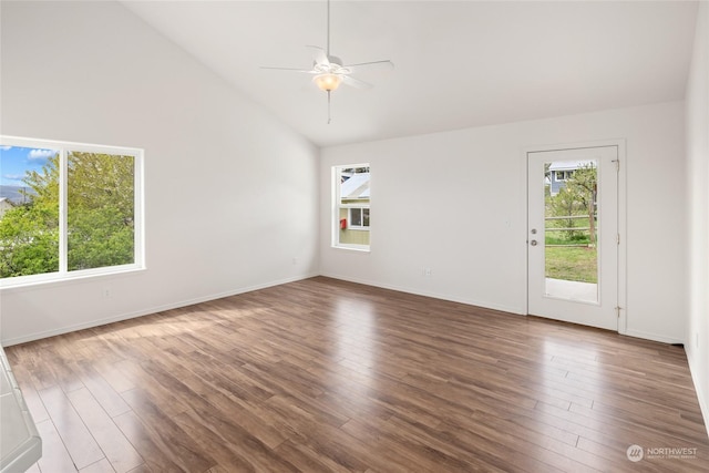 spare room featuring high vaulted ceiling, dark hardwood / wood-style floors, and ceiling fan