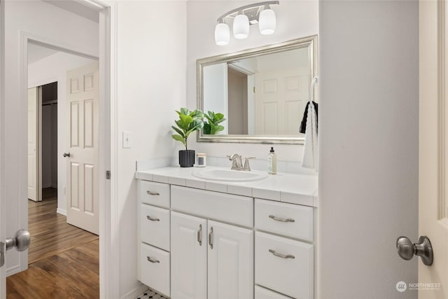 bathroom with vanity and hardwood / wood-style flooring