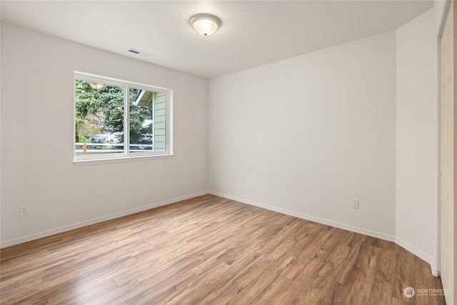 empty room with light hardwood / wood-style floors