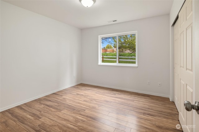 unfurnished bedroom with a closet and light wood-type flooring