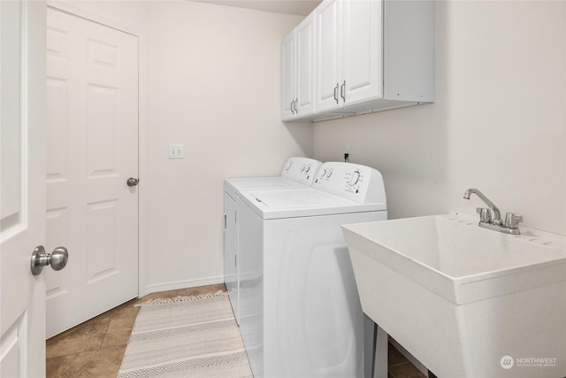 laundry area featuring cabinets, light tile patterned flooring, separate washer and dryer, and sink