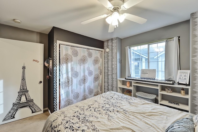 bedroom featuring ceiling fan, a closet, and light carpet