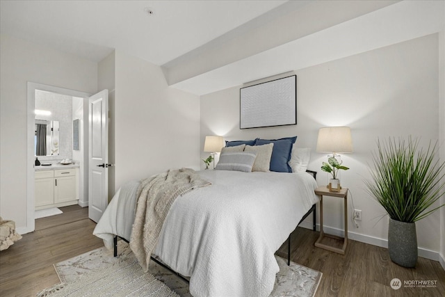 bedroom featuring ensuite bathroom and hardwood / wood-style floors