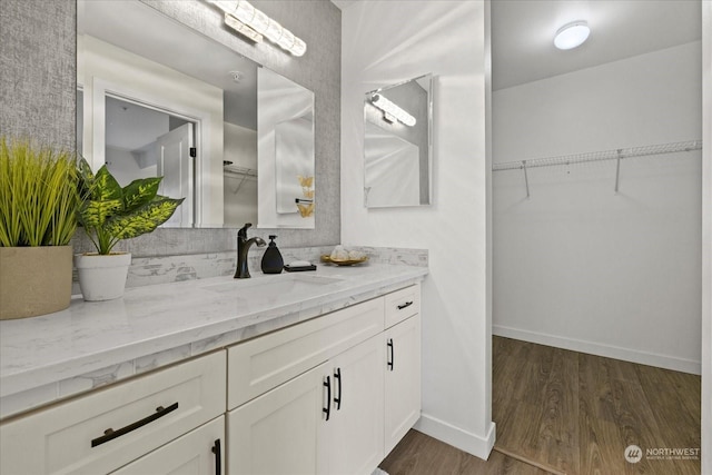 bathroom with hardwood / wood-style floors and vanity