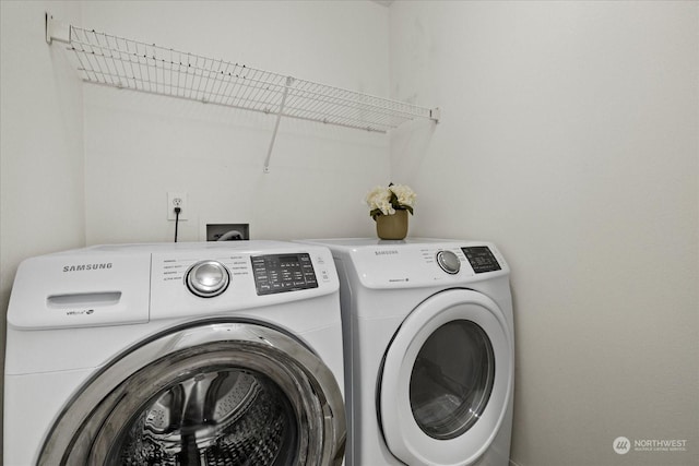 clothes washing area featuring washing machine and clothes dryer