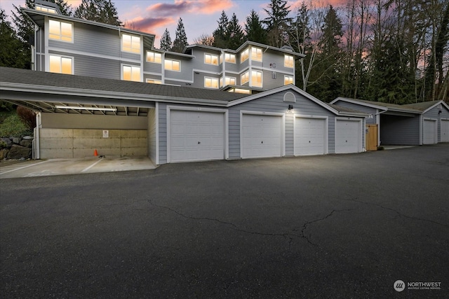 view of garage at dusk