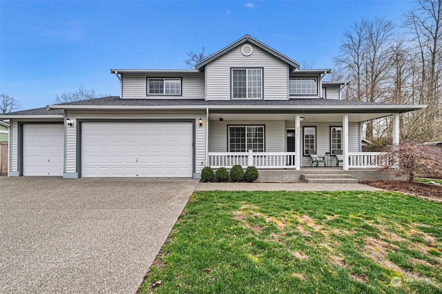 view of front of property with a front lawn, a garage, and a porch