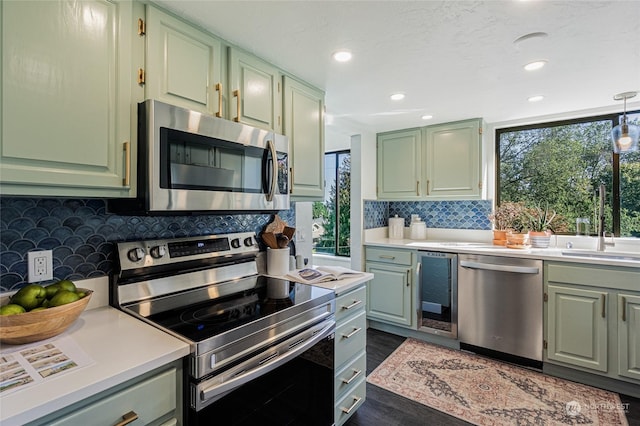 kitchen featuring dark wood-type flooring, green cabinets, sink, wine cooler, and stainless steel appliances