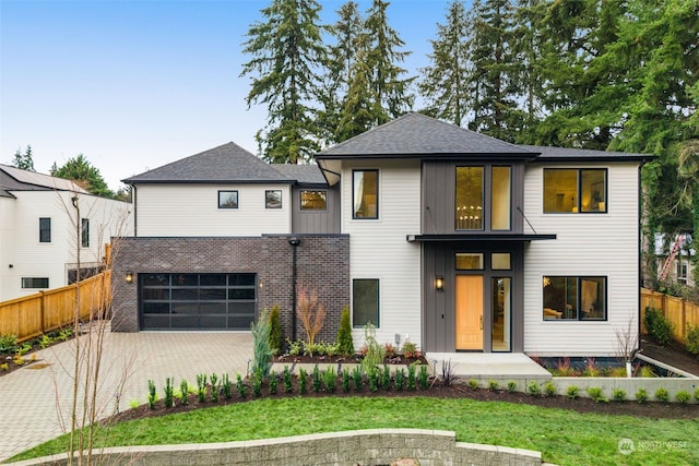 view of front facade with a garage and a front lawn