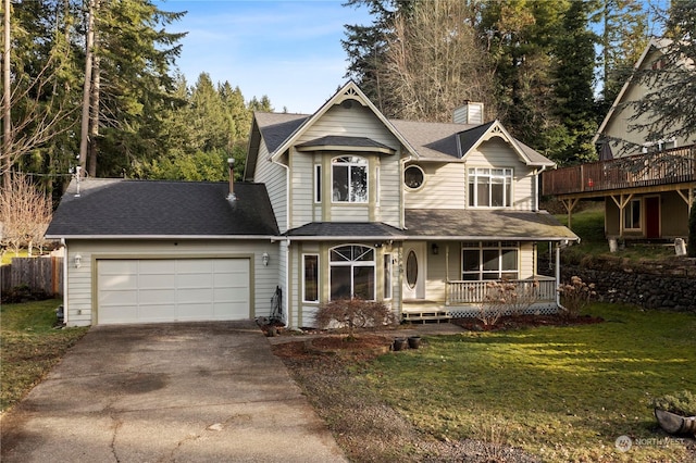 view of front of home featuring a garage, a porch, and a front lawn