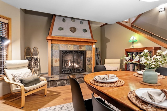 dining area with a fireplace and light wood-type flooring