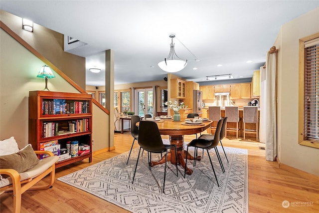 dining area with light hardwood / wood-style floors