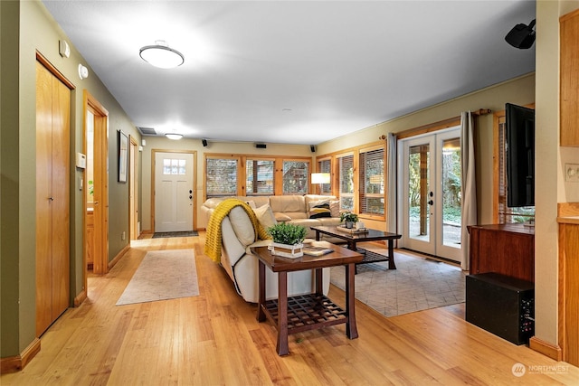 living room with light hardwood / wood-style floors and french doors