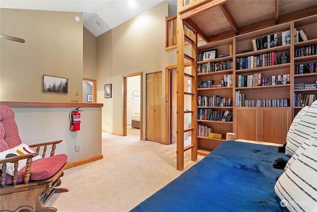 interior space featuring high vaulted ceiling and light carpet