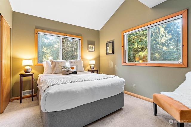 carpeted bedroom featuring vaulted ceiling