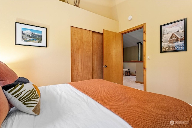 bedroom featuring light carpet and a closet