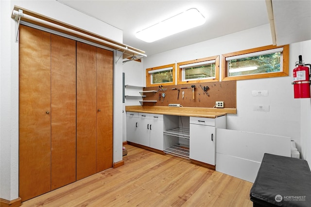 kitchen with white cabinetry and light hardwood / wood-style floors