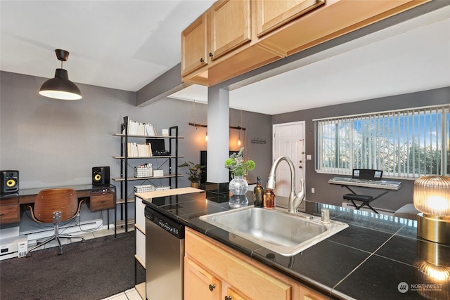 kitchen featuring sink, light brown cabinets, stainless steel dishwasher, pendant lighting, and carpet