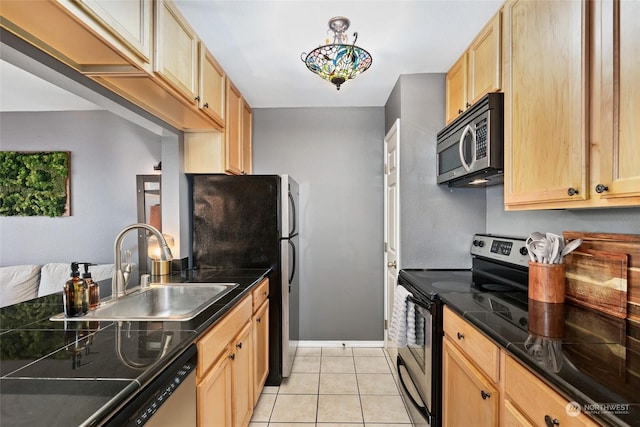 kitchen with light brown cabinetry, sink, light tile patterned flooring, and stainless steel appliances