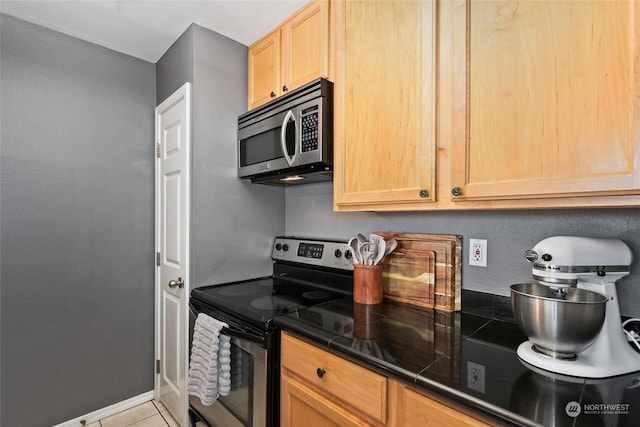 kitchen with appliances with stainless steel finishes, light brown cabinets, and light tile patterned floors