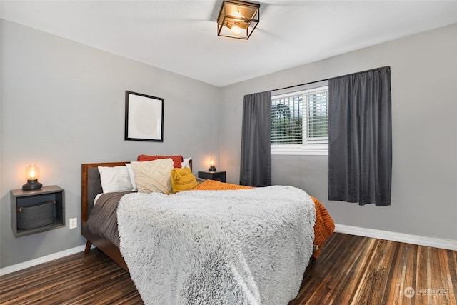 bedroom with dark wood-type flooring