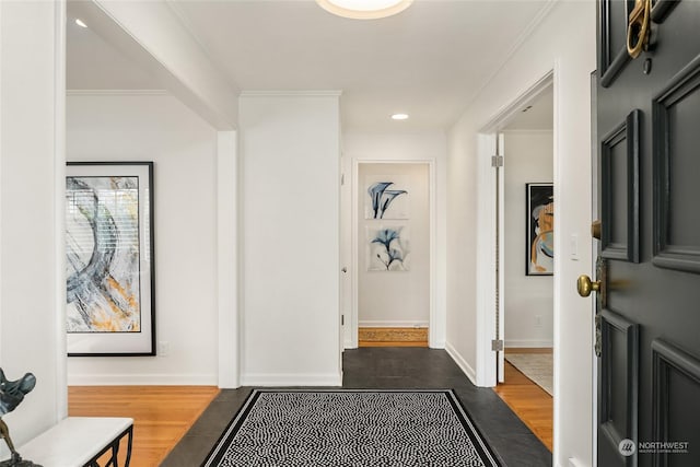 hallway with crown molding and dark hardwood / wood-style floors