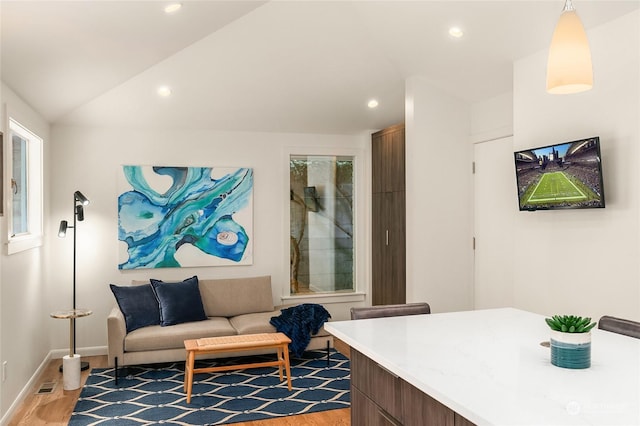 sitting room featuring lofted ceiling and wood-type flooring