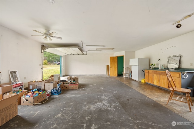 garage featuring white fridge and ceiling fan